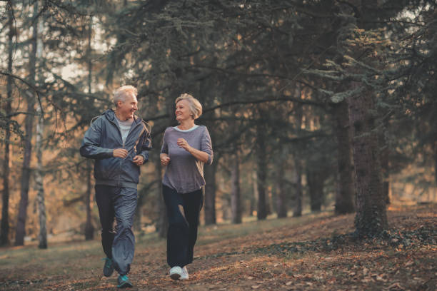 istock Senior couple jogging in a forest 1097401444