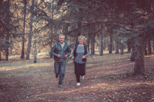 istock Senior couple jogging in a forest 1097401590