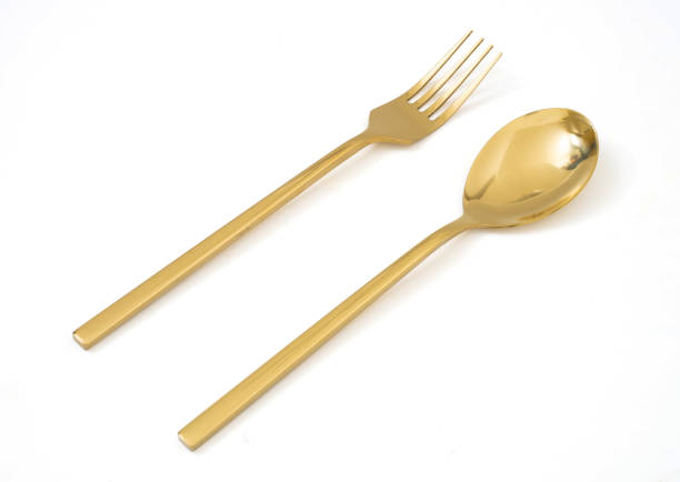 istock golden spoon and fork isolated on a white background 1097402218