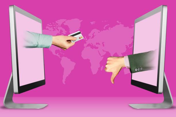 istock hi-tech concept, two hands from displays. hand with credit card and thumbs down, dislike. 3d illustration 1097402360