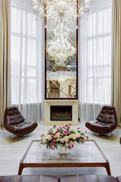 istock Mirror over fireplace and leather armchairs around. 1097403488
