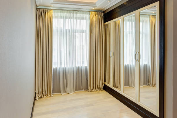 istock Big wardrobe with mirror built into the wall. 1097404012