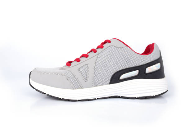 istock Gray sneakers with red laces on a white background 1097404526