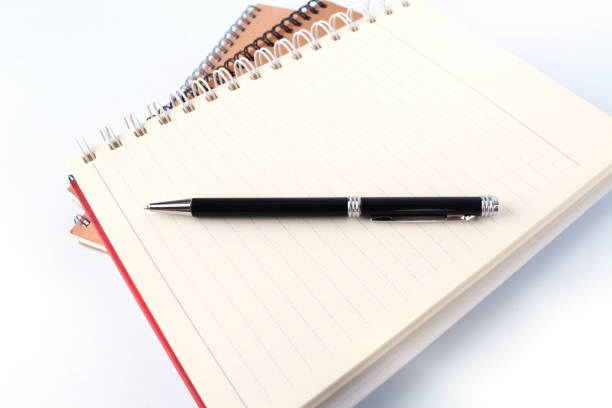 istock Open book with blank pages and pen on white background 1097404626