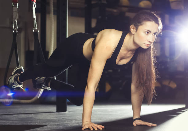 istock Young women doing exercise with suspension 1097405226
