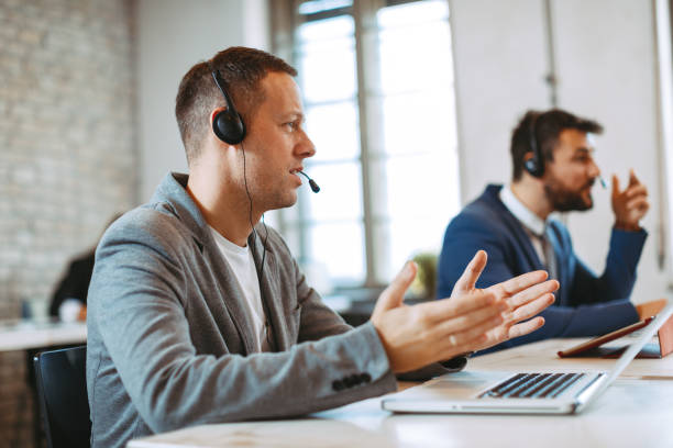 istock Man customer service talking on the headset with client and smiling 1097405366