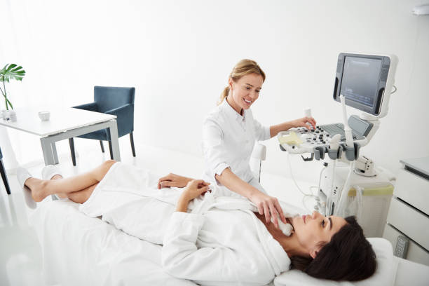 istock Friendly doctor doing thyroid ultrasound test for young woman 1097405686