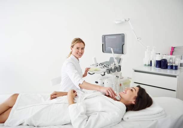 istock Smiling doctor doing thyroid ultrasound test for young woman 1097405696