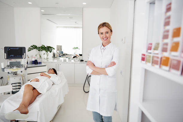 istock Charming cosmetologist posing with crossed arms while young lady resting 1097405744