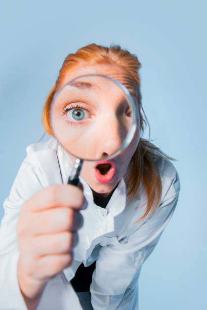 istock Portrait of scientist using magnifying glass 1097406298