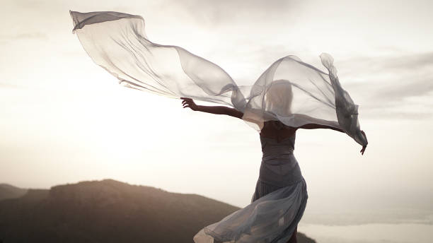 istock Catching wind. Woman in elegant gown posing in mountains 1097406414