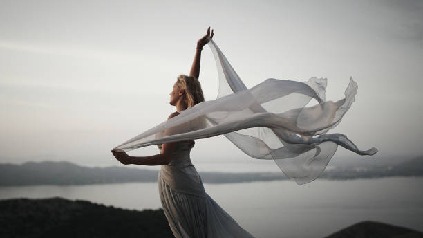istock Catching wind. Woman in elegant gown posing in mountains 1097406436