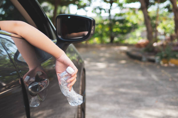 istock Hand throwing plastic bottle on the road 1097409522