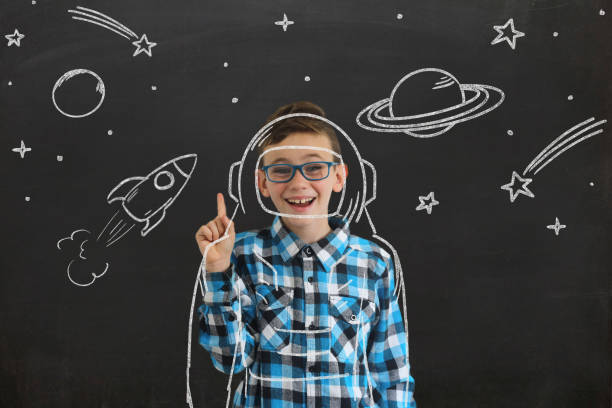 istock Young boy child think idea dreaming imagination space stars 1097411826