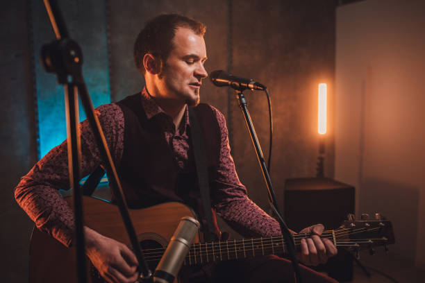istock Handsome musician singing and playing acoustic guitar 1097412544