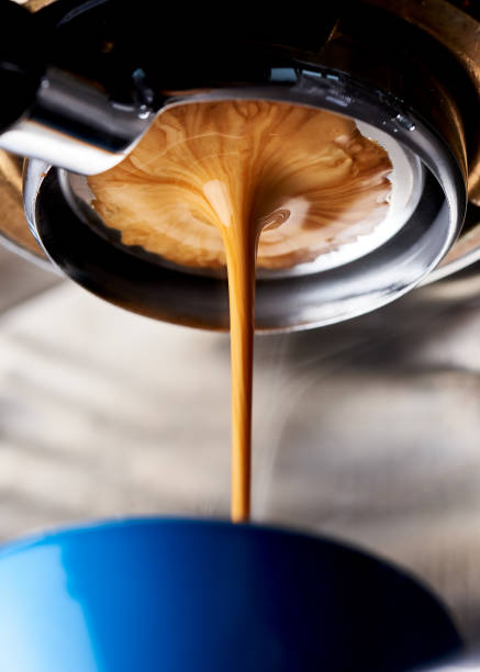 Pulling a shot of espresso on a naked portafilter A perfect espresso shot extraction using a naked (bottomless) portafilter. This is a light roasted Ethiopia specialty coffee from a local roaster.f espresso maker stock pictures, royalty-free photos & images