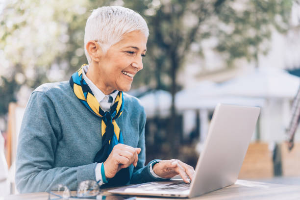 istock Mature businesswoman working at cafe 1097414898