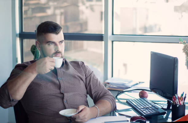 istock Thoughtful bearded businessman having break, drinking coffee at your workplace.  Inspired with cup of fresh coffee. 1097415474