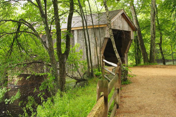 istock Covered bridge around the corner in the woods 1097415616