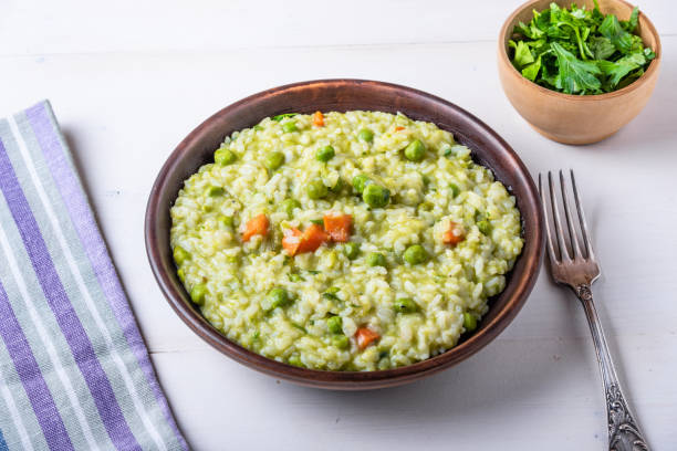 istock Traditional Italian vegetarian risotto with peas in rustic style 1097417076
