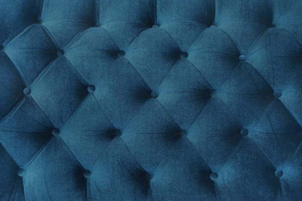 istock Navy Velvet couch background texture with sunken buttons. 1097419990