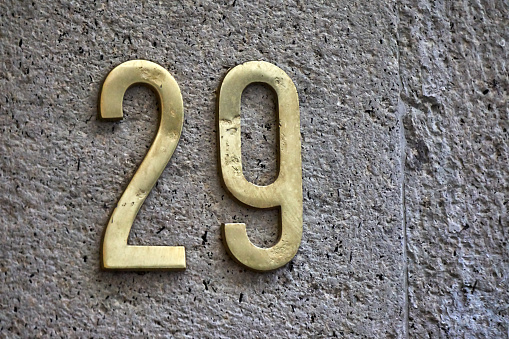 golden house number on concrete