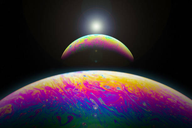 istock Macrophotograph of a colorful soap bubble looking like a planet with a shadow crescent 1097427830