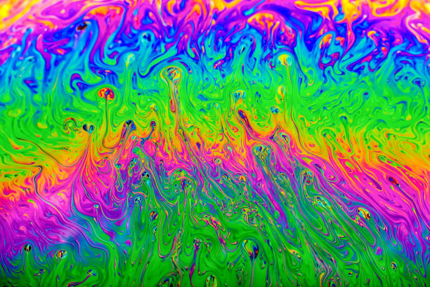Swirling shapes and colors at the surface of a soap bubble stock photo