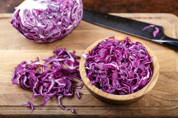 istock chopped purple cabbage in a plate on a cutting board. 1097428678