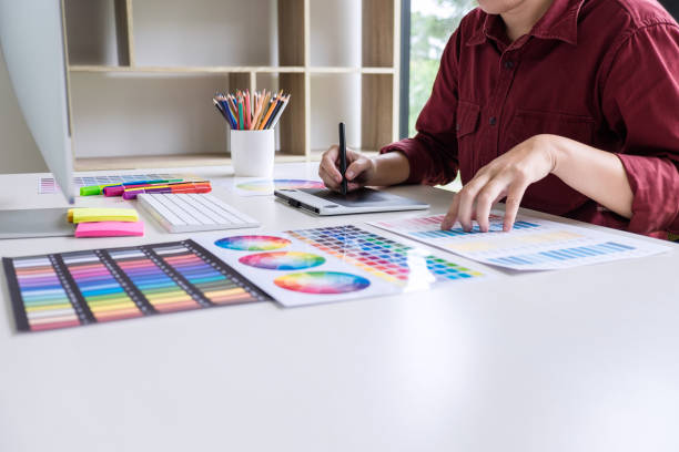 istock Image of female creative graphic designer working on color selection and drawing on graphics tablet at workplace 1097429022