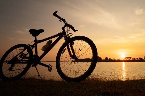 istock Silhouette bicycle with sunset or sunrise background 1097431222