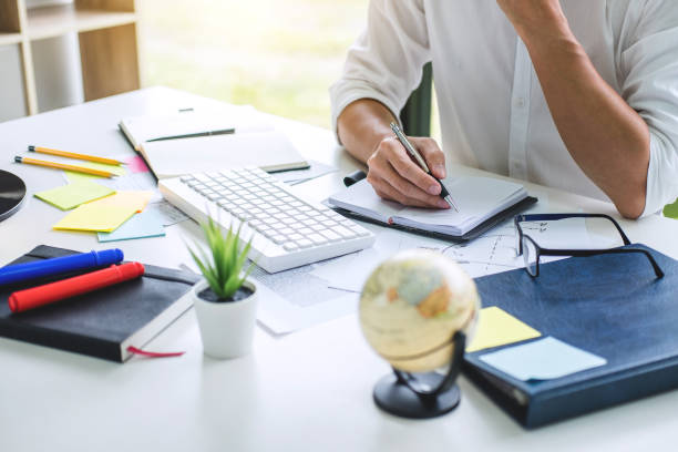 istock Businessman working writing business plan document and graphic designer with computer in office 1097431318