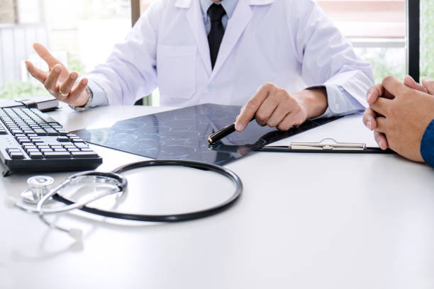 istock Professor doctor recommend report a method with patient treatment, results on examine a picture brain x-ray film about the problem of the patient while working in office 1097432208