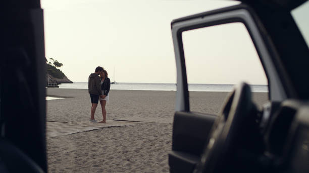 istock Couple escaping to the beach. Looking through SUV window 1097432326