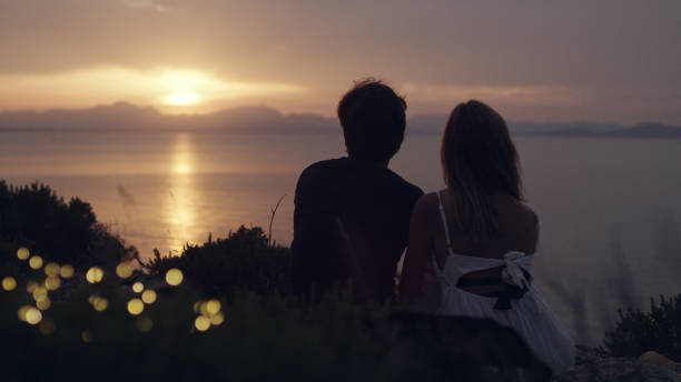 istock Romantic date on a cliff. Waiting for sunset 1097432572