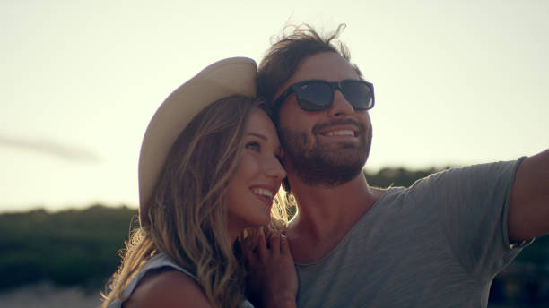 istock Couple making selfie at the beach. Sunset 1097432690