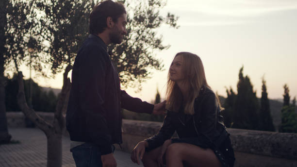 istock Happy couple on vacations. Flirting on park bench 1097432806
