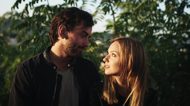 istock Happy couple on vacations. Cuddling in the park 1097432944