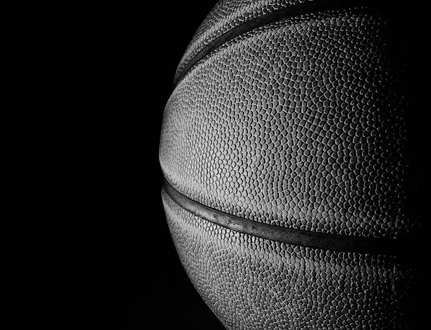 Basketball black and white closeup on black Closeup of a basketball in black and white, on black background for copy space basketball ball photos stock pictures, royalty-free photos & images