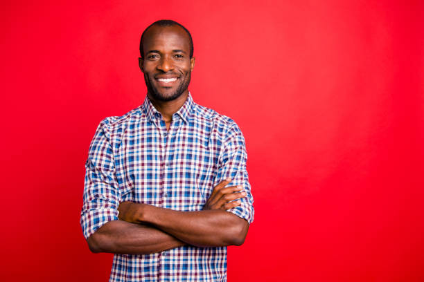 Portrait of nice handsome well-groomed attractive cheerful positive cheery guy wearing checked shirt isolated over bright vivid shine red background Portrait of nice handsome well-groomed attractive cheerful positive cheery guy wearing checked shirt isolated over bright vivid shine red background stubble male african ethnicity facial hair stock pictures, royalty-free photos & images
