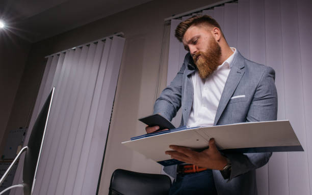 istock Bearded businessman working with files 1097434748