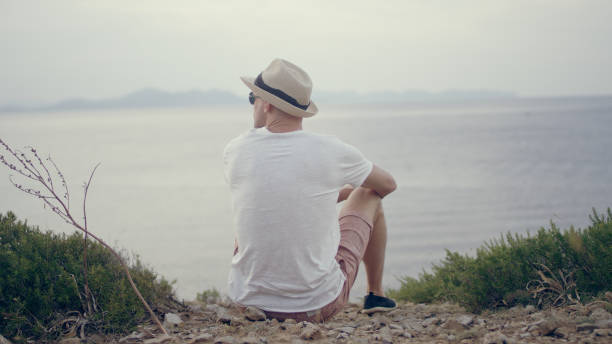 istock Man enjoying view form a cliff. Peaceful sea 1097435326