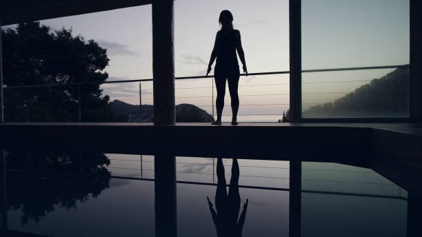istock Vinyasa flow. Woman doing yoga by the pool. Mountain pose 1097435362