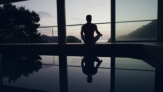 Keeping balance in yoga poses. Morning relaxation during sunrise