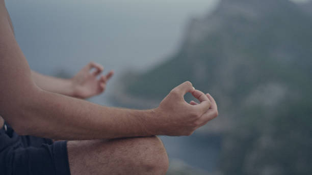 istock Man meditation. Rocky coastline. Close up on hands 1097435464