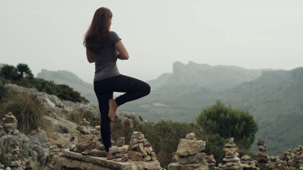 istock Woman meditation. Rocky coastline 1097435470