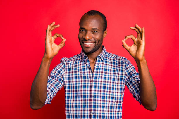 istock Portrait of nice cool attractive handsome cheerful positive optimistic guy wearing checked shirt showing double two ok-sign isolated over bright vivid shine red background 1097436090