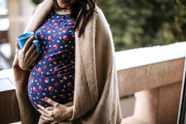 istock Happy pregnant woman drinking coffee 1097442444
