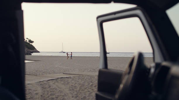 istock Couple escaping to the beach. Looking through SUV window 1097443898