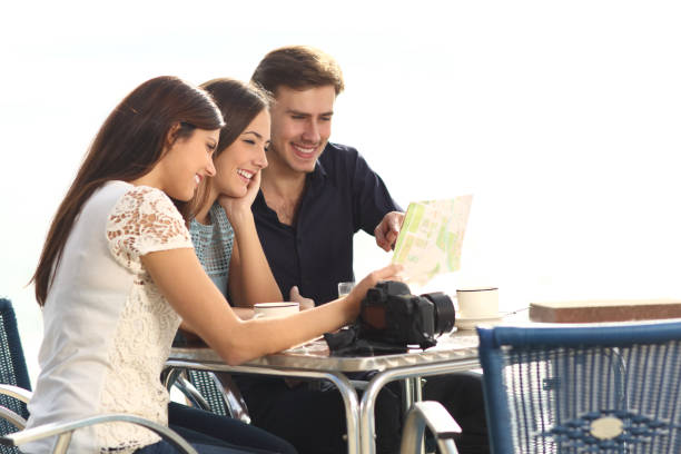 istock Three tourists checking guide in a coffee shop 1097444470
